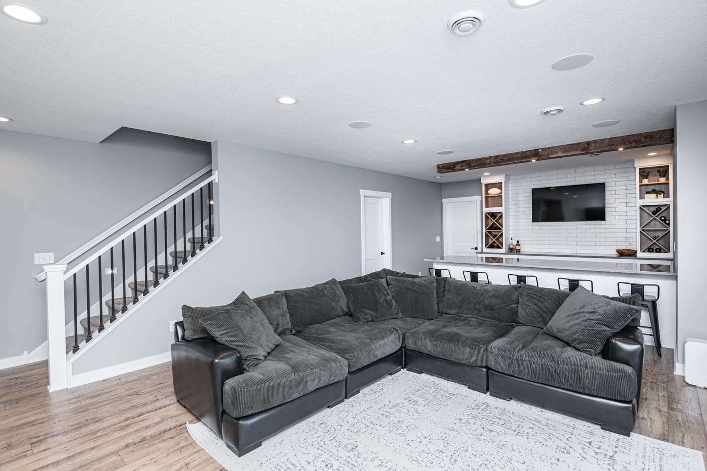 The Quarry Hill — finished basement by MN Living Co. in Rochester, MN: family room and stairs