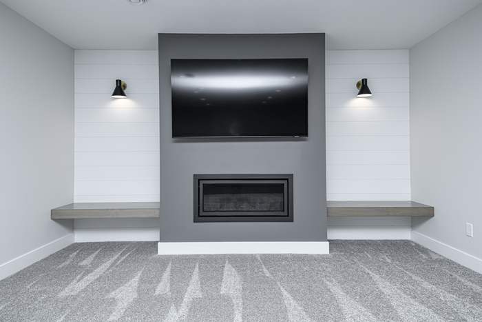 The Slate — finished basement: fireplace feature wall